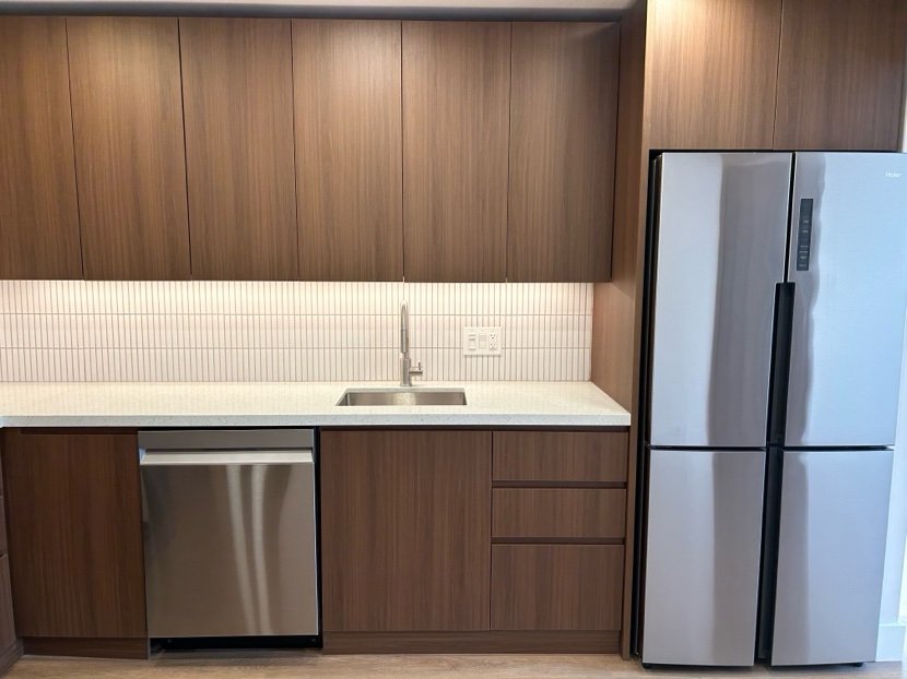 Renovated Admiral Apartments kitchen with modern cabinetry and stainless appliances