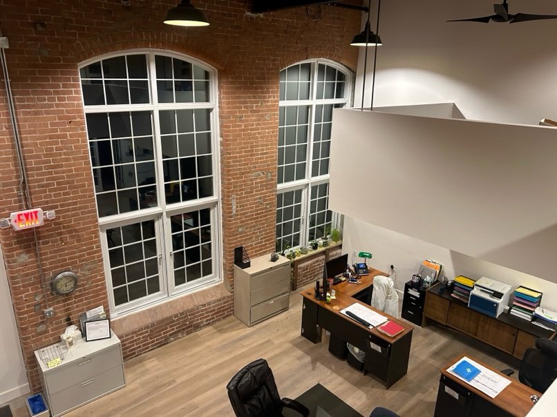 Renovated mill interior with original brick walls and arched windows